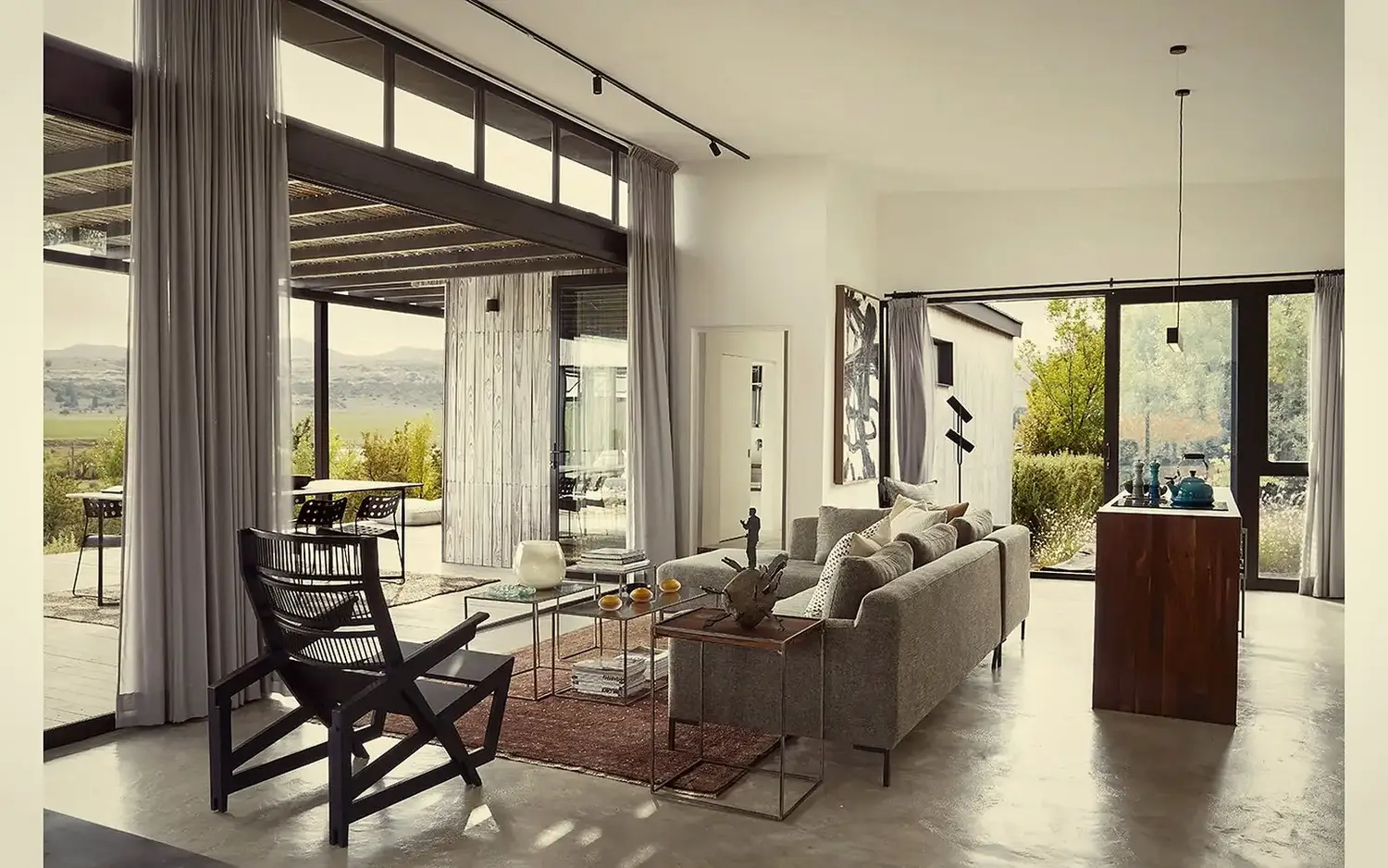 Living room · concrete floor, sliding doors, full-height curtains