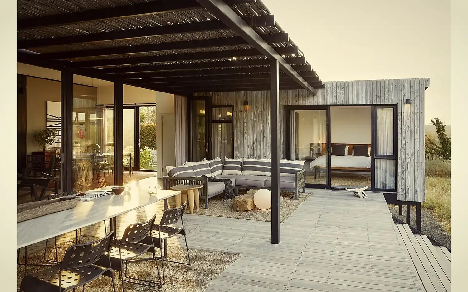 Covered terrace with sofa, bedroom door open beyond